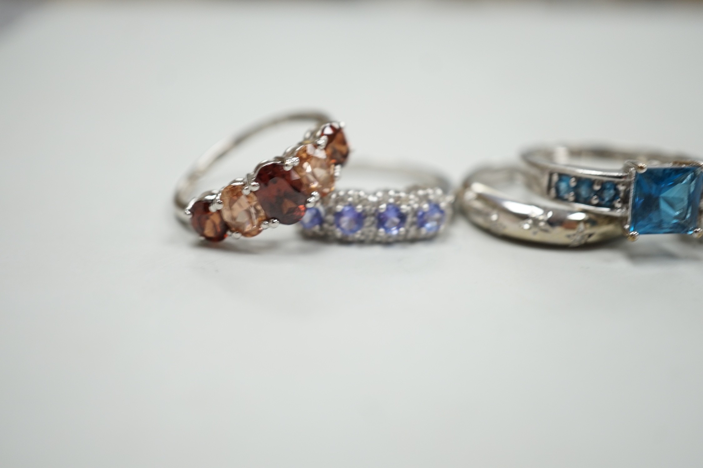 Five assorted modern 9ct white gold and gem set dress rings, including gypsy set diamond chip, gross weight 12.6 grams.